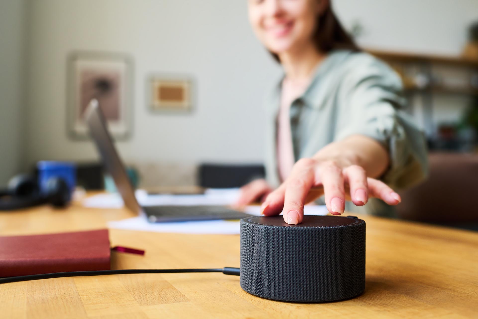 Woman on a laptop using voice assistant with wireless internet connection